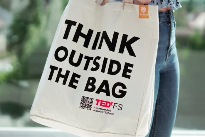 A tote bag with the print "Think outside the bag" for TEDx