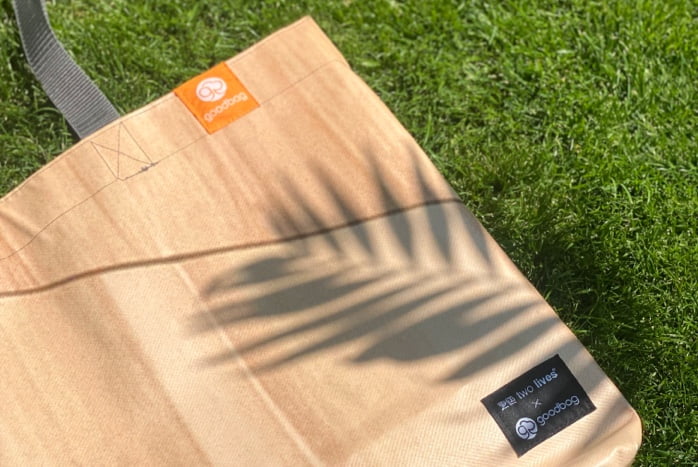 An upcycled goodbag lying on grass